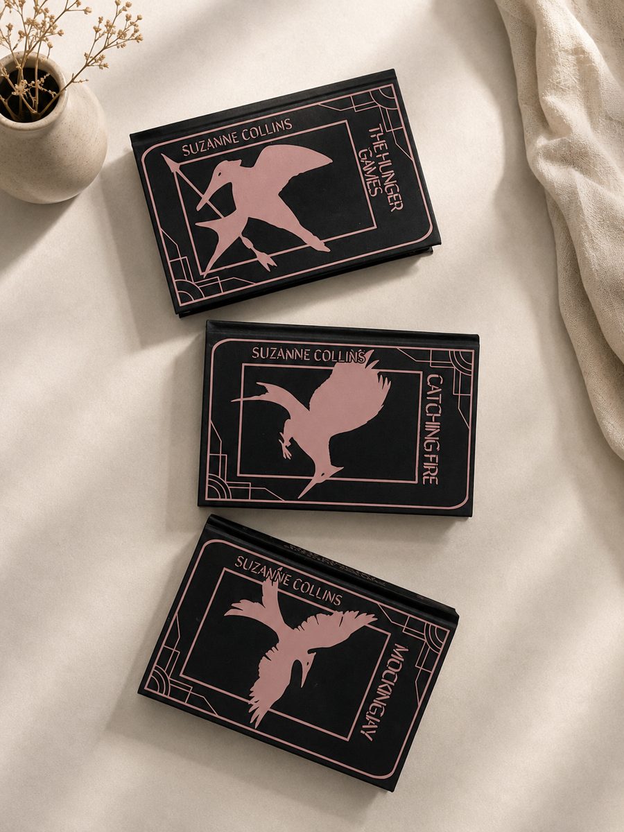 The Hunger Games trilogy rebind, black covers with rose gold foil